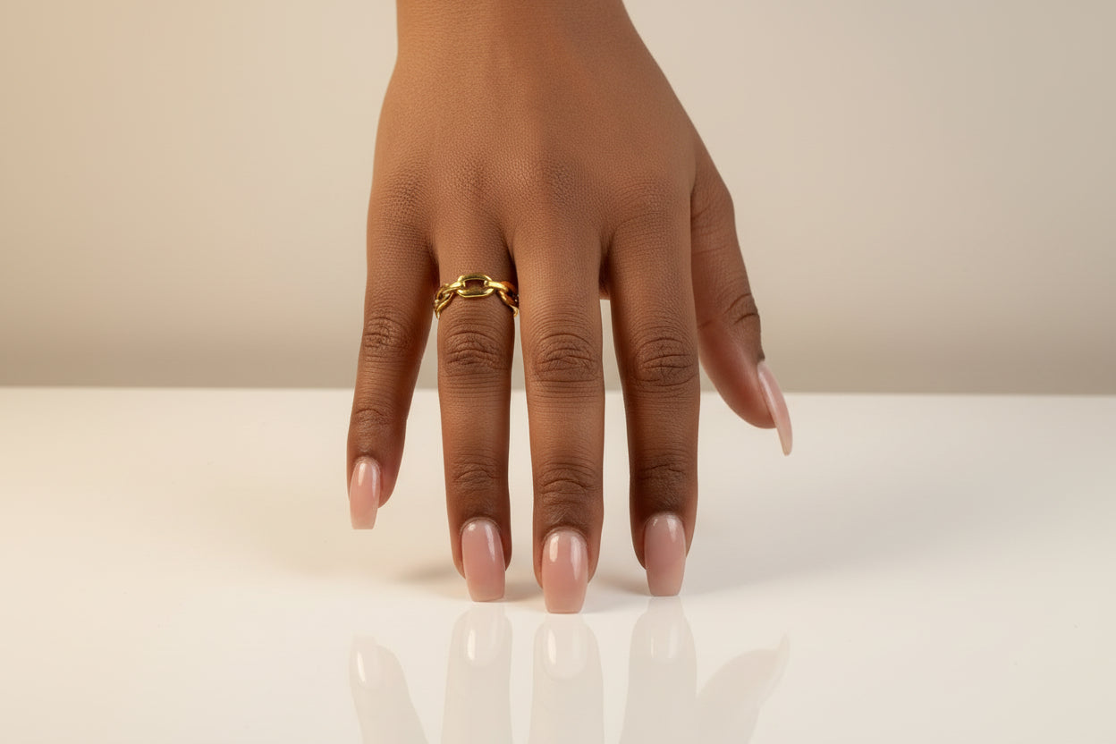 Hand wearing a 18 gold ring on a white background