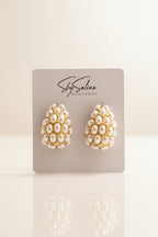 Pair of pearl-like earrings 18 gold in studio image