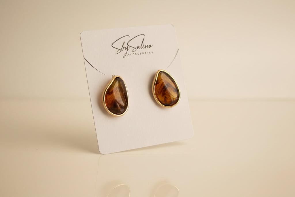 Pair of amber-colored 18k gold earrings  studio image