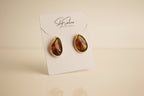 Pair of amber-colored 18k gold earrings  studio image