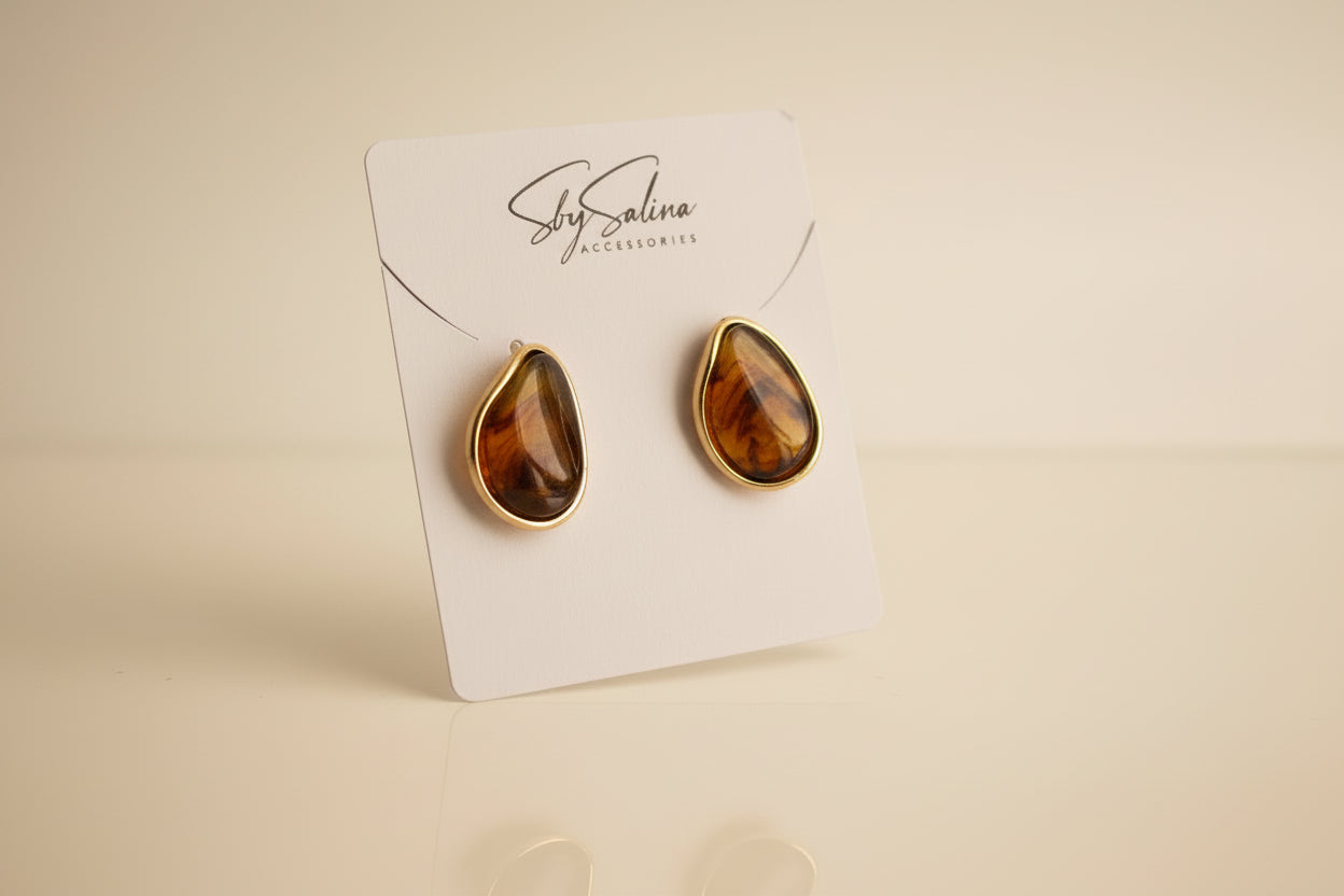 Pair of amber-colored 18k gold earrings  studio image